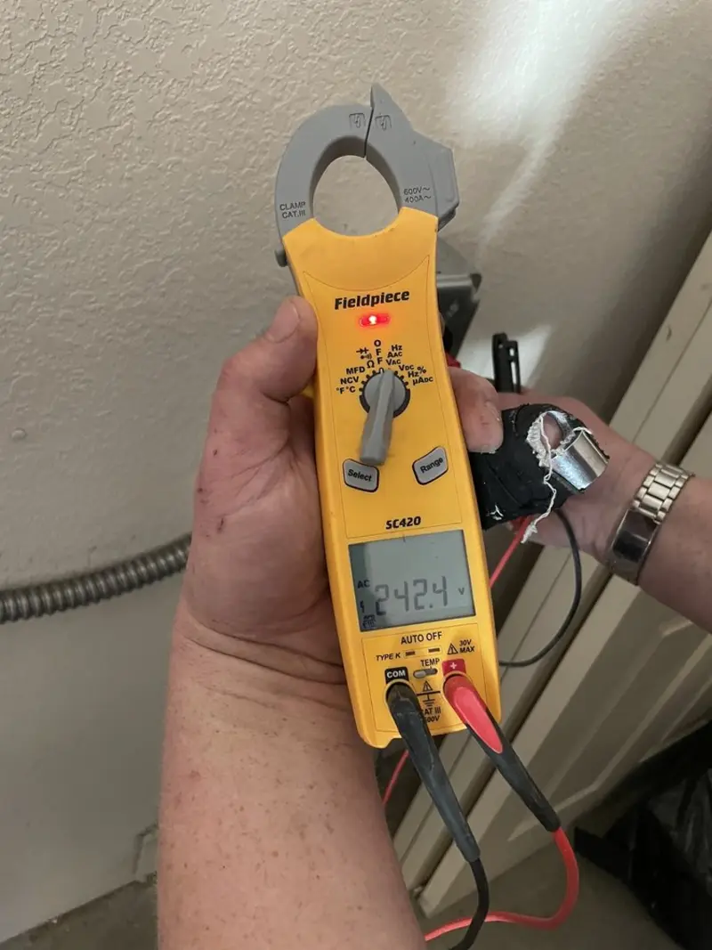 Voltage testing with clamp meter during Whole House Surge Protector in Janesville